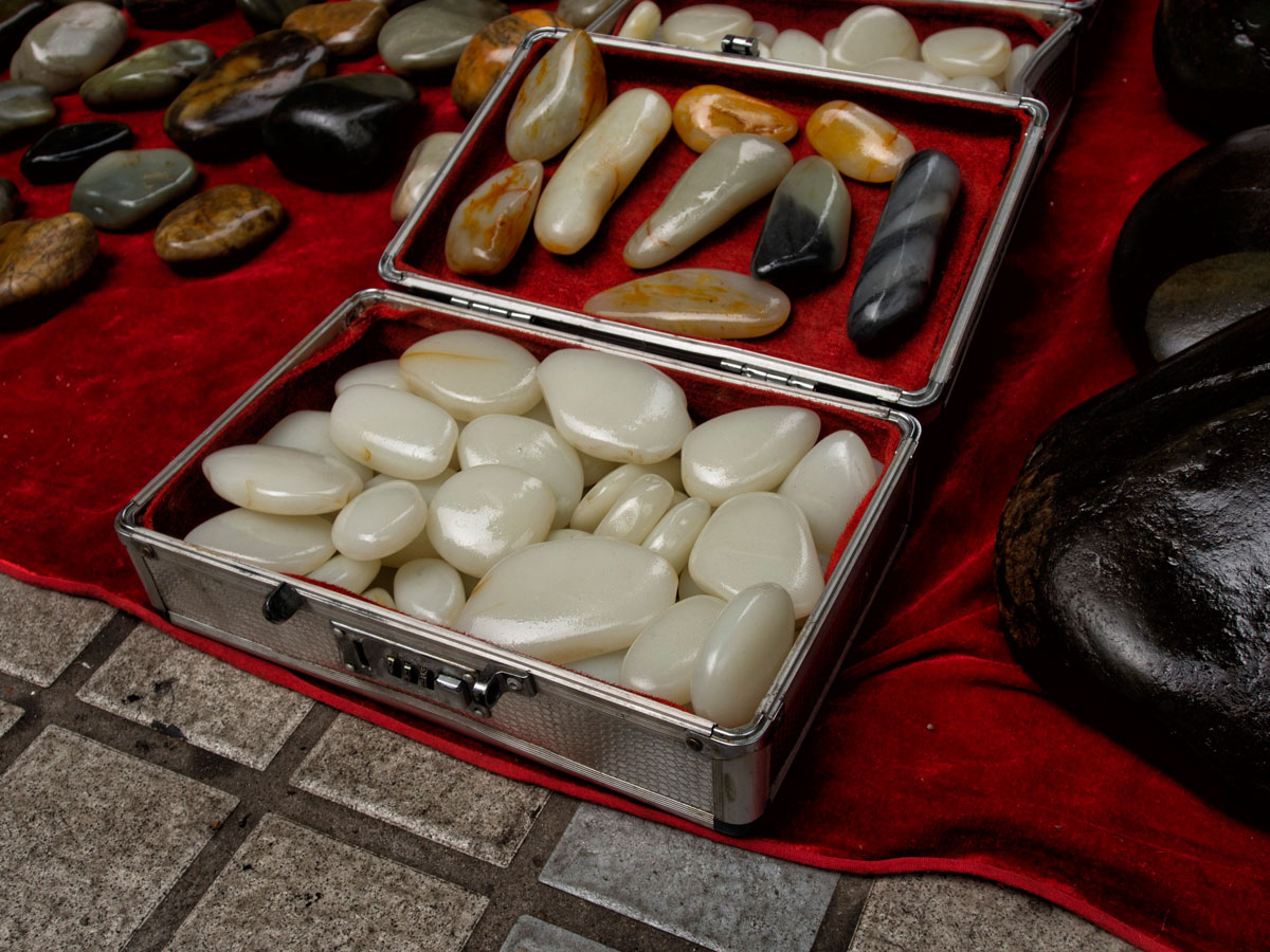 Figure 6. A suitcase of what appears to be Chinese nephrite in Guangzhou's Hualin Street jade market. Like many gem markets, caveat emptor is the norm as imitations abound. Photo: Richard W. Hughes.