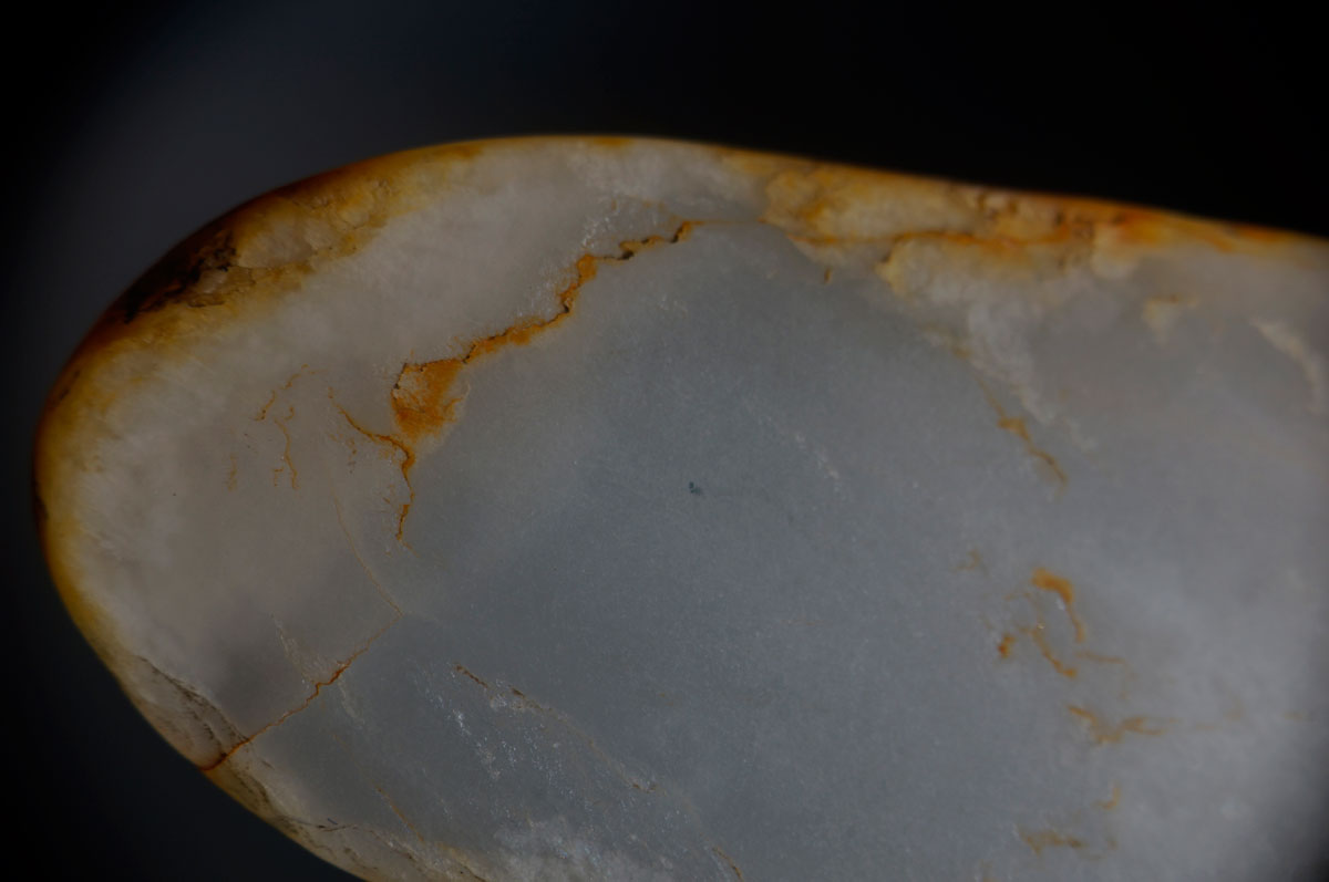 Figure 11. Chinese white nephrite with iron oxide stains purchased in Guangzhou's Hualin Street jade market. Photo: Wimon Manorotkul.