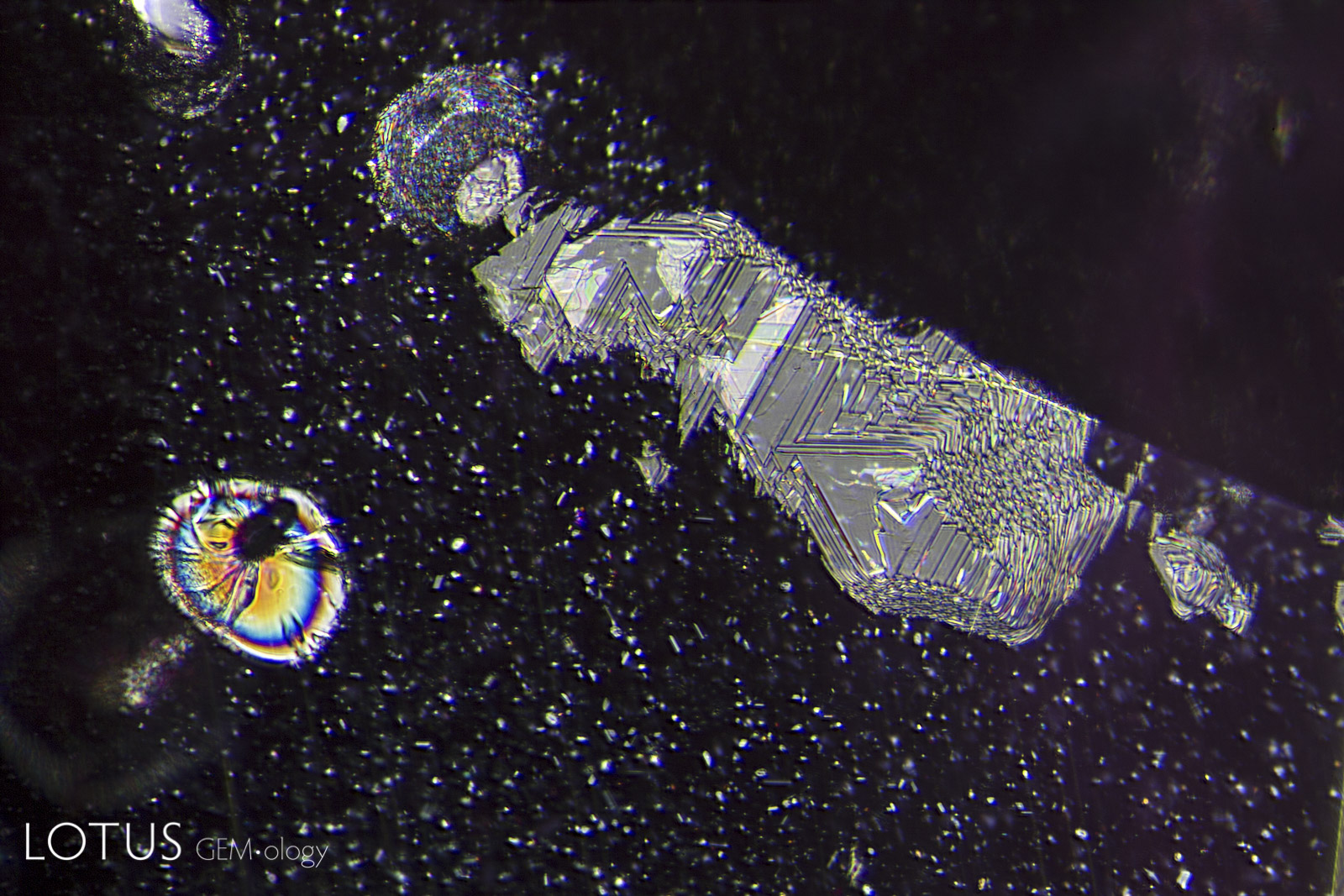 Left: A heat-altered crystal with an iridescent decrepitation halo, alongside a surface cavity filled with glass.