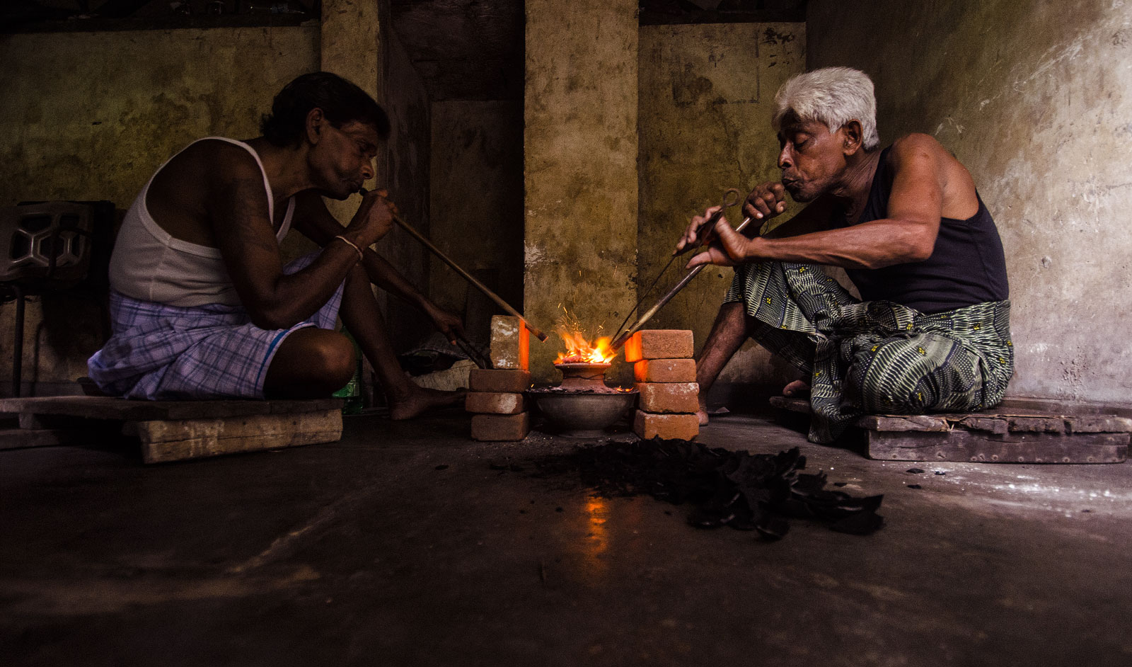 Treaters practicing the ancient art of blowpipe heating in Ratnapura, Sri Lanka. As described by al Beruni ca. 1045 AD, the temperatures reached by this technique exceeds that of the melting point of gold (1064°C)