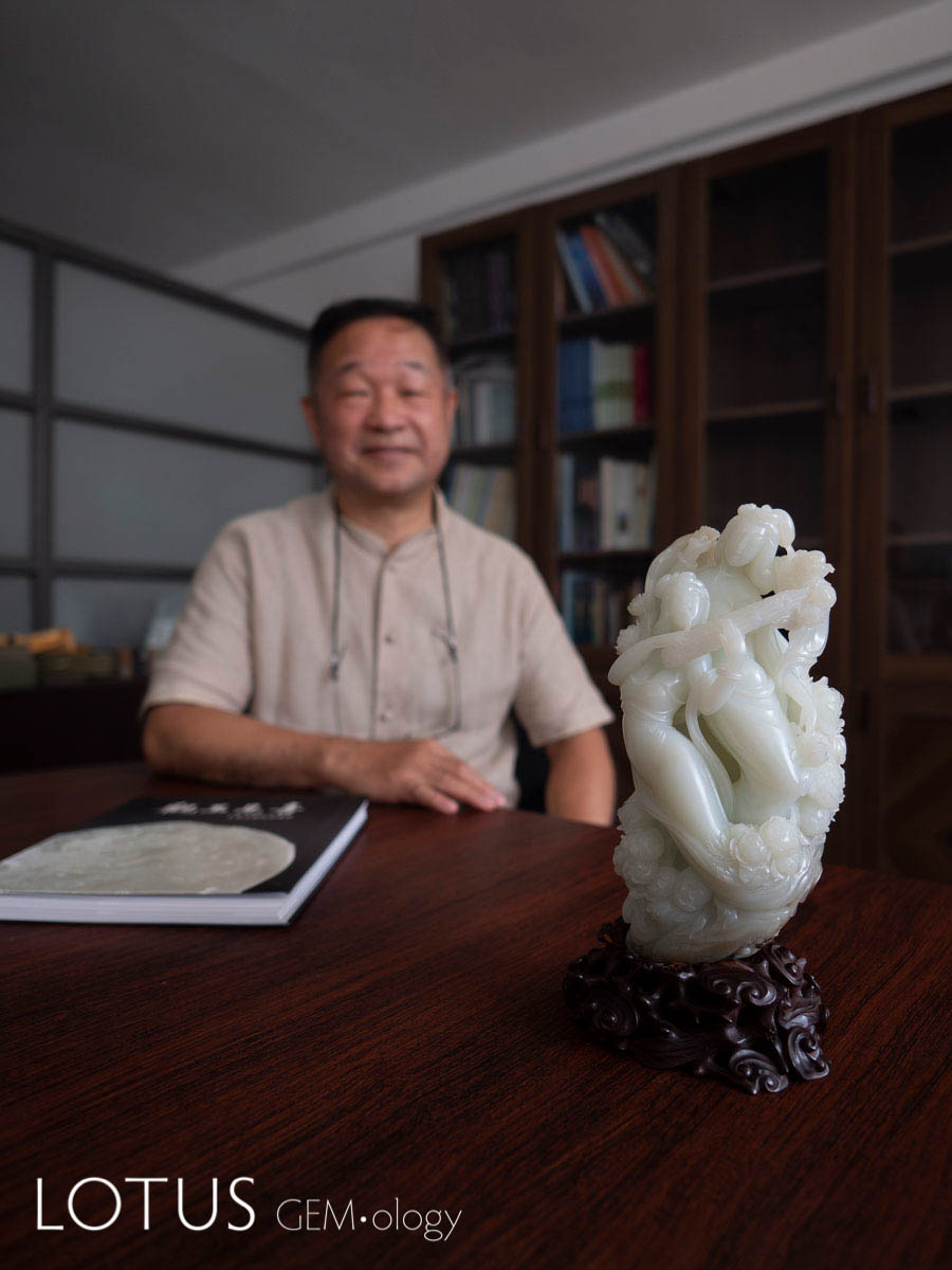 Lin Tze-Chuan with his book Joyful Forms of Beautiful Jade (2016), along with "Sing and Dance to Extol the Good Times" by Wu Desheng. This lovely carving depicts a beautiful lady dancing with peony blooms. The happy, heartfelt expression shows that she is grateful to live in a joyous era. Hetian "mutton fat" nephrite from Xinjiang, China; 10.1 x 20.7 x 6.5 cm.; 2008. Photo: Richard W. Hughes. Click on the photo for a larger image