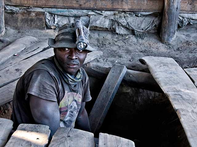 A graphite-coated miner emerges from the shaft at Merelani's Block D. Photo: Richard W. Hughes