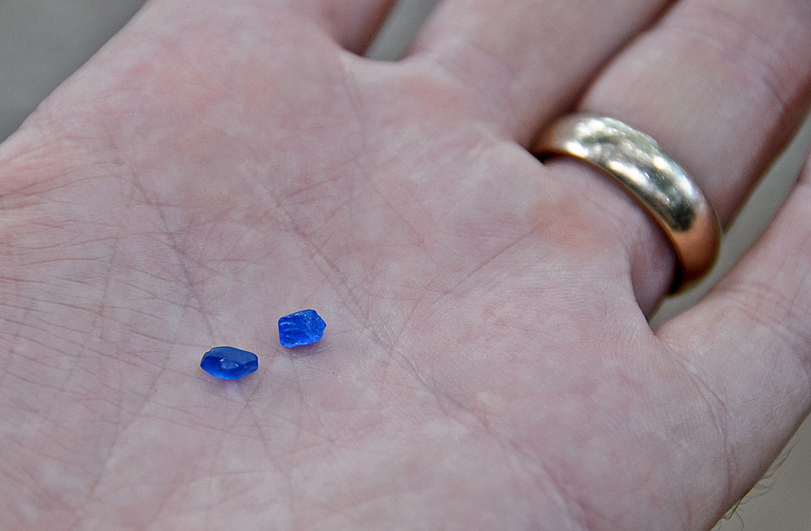 These two blue spinels were purchased by the GIA's Vincent Pardieu in Vietnam's Luc Yen mining district. Price paid was $5. While one turned out to be a rare natural cobalt-colored spinel, the other proved to be synthetic. Photo: Vincent Pardieu/Fieldgemology.org