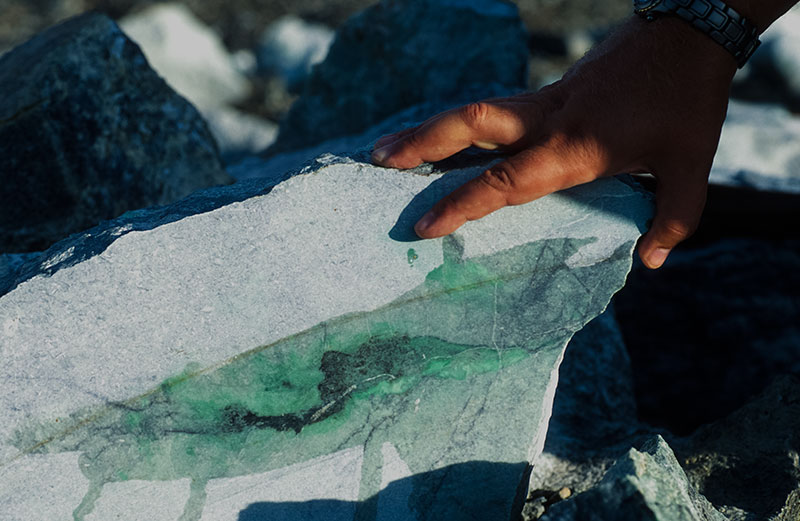 Green veins are clearly visible in this large block of jadeite at Lot 88 in the Polar Urals jade mines