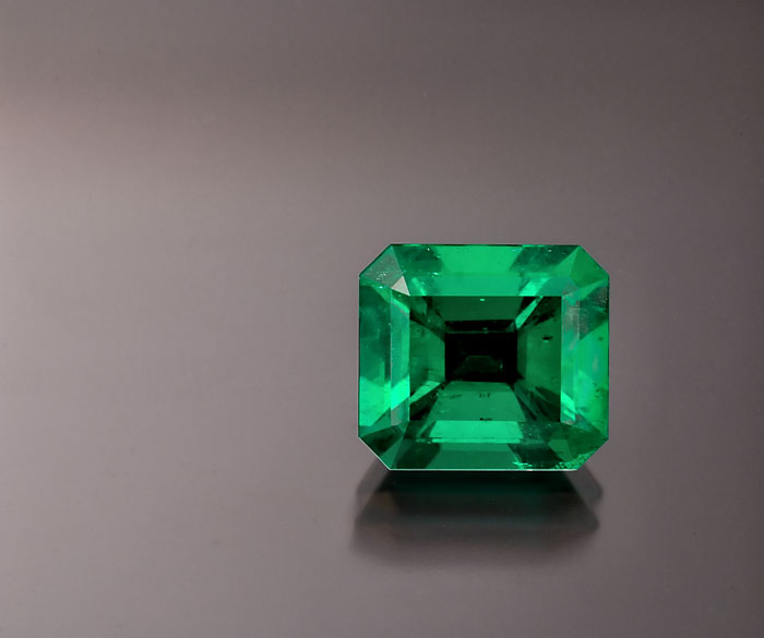 Figure 5. Emerald was once thought to be colored solely by chromium; indeed, many gemologists argued that the definition of emerald must include the presence of chromium. When vanadium-colored emeralds were discovered, the problem with this definition was clearly revealed. In reality, jewelers have no easy way of determining a gem's coloring agent. What they do have are eyes that can see green in a variety of nuances. Gemology cannot live solely in a test-tube environment. It must take into account commercial realities and aesthetic factors. Photo: Wimon Manorotkul; specimen: Palagems.com.