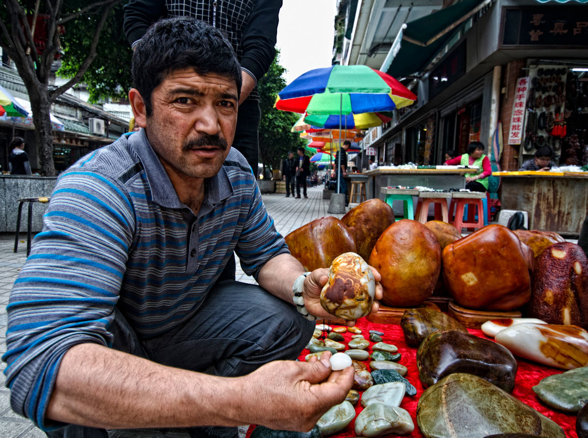 Figure 5. A Uighur man showing what looks like Chinese nephrite in Guangzhou's Hualin Street jade market. Photo: Richard W. Hughes.