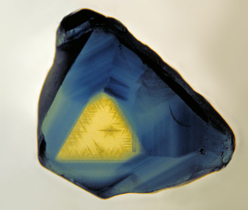 Figure 6. Outer triangulation… A thin polished slice of an Australian sapphire, looking parallel to the c-axis (parallel to the prism faces. The three-fold symmetry is clearly visible. Photo © Richard W. Hughes