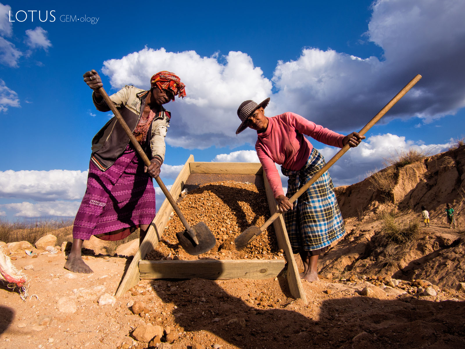 Sapphire Miners Near Ilakaka, Madagascar Figure 3. Miners move gem-bearing gravel near Ilakaka. Most of the sapphire production in Madagascar is by small-scale miners working with artisanal tools. Photo by E. Billie Hughes.