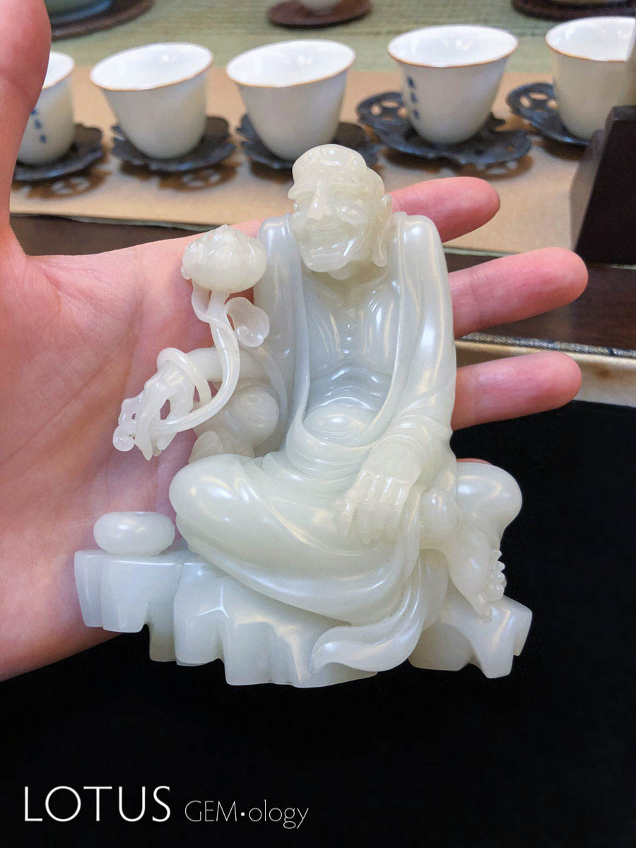 Sixteenth Arhat by Wu Desheng. Wu Desheng told the author (EBH) that intricate figures such as this (complete with rotatable jade bangle bracelet) are exceedingly difficult to carve. Hetian "mutton fat" nephrite from Xinjiang, China. 10.4 x 9.35 x 5.2 cm; 2003. Photo: E. Billie Hughes. Click on the photo for a larger image
