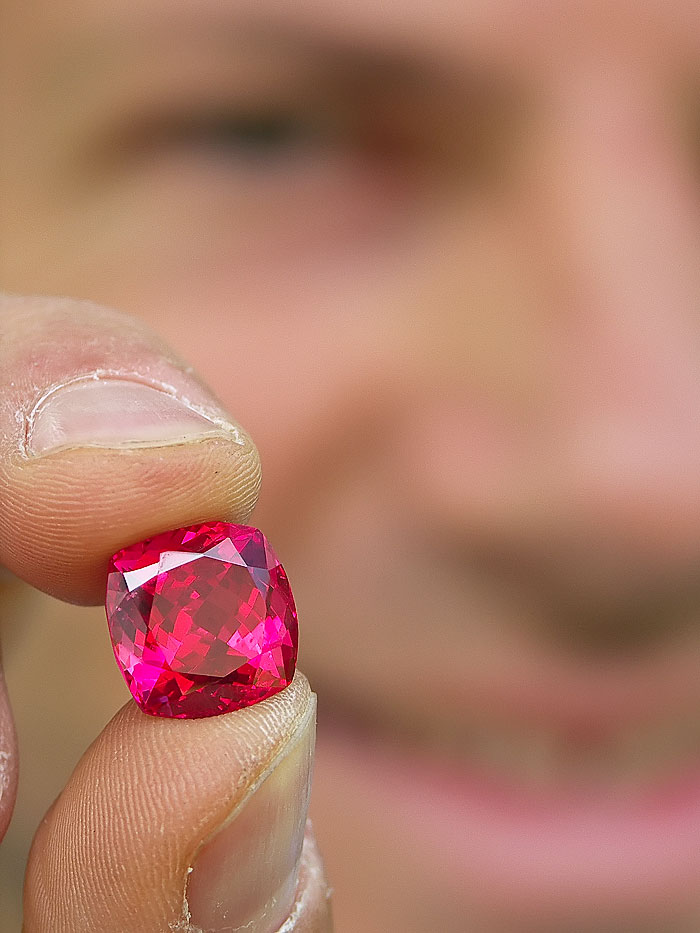 Eric Saul displays a spectacular red Mahenge spinel, cut from one of the large crystals found in the summer of 2007. Among connoisseurs, the finest Mahenge spinels have acquired a reputation second-to-none. Photo: Vincent Pardieu