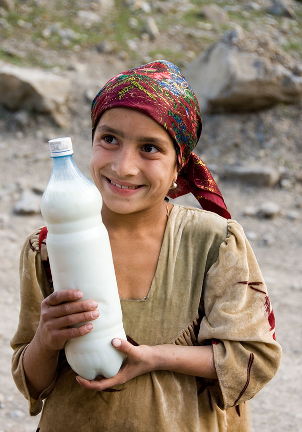 Got milk? A Tajik girl offers fermented milk to weary travelers in the remote Badakhshan region of Tajikistan. Photo © Richard W. Hughes.
