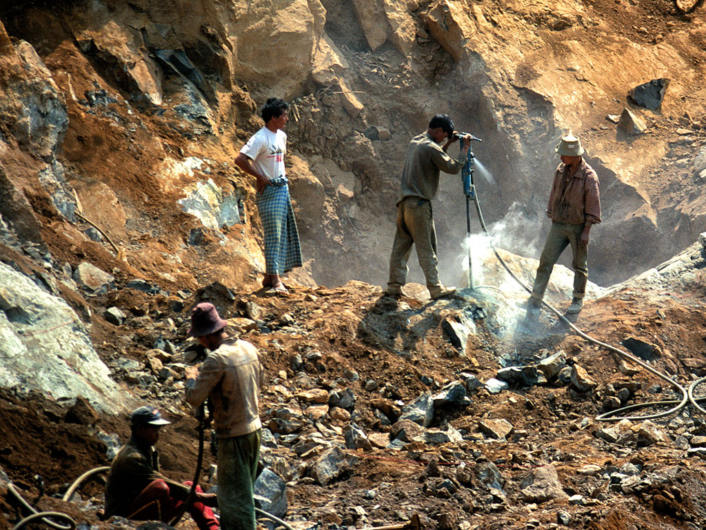 Figure 6. Once a dike is exposed at Tawmaw, jackhammers are needed to break the jadeite apart. Photo © Richard W. Hughes.