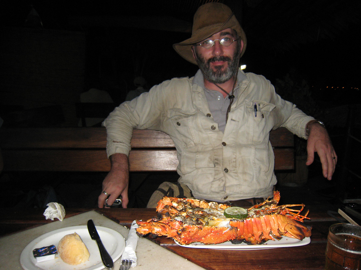 Roughing it abroad. Vincent Pardieu enjoys a small lobster in Pemba. Photo: Richard Hughes/Lotus Gemology