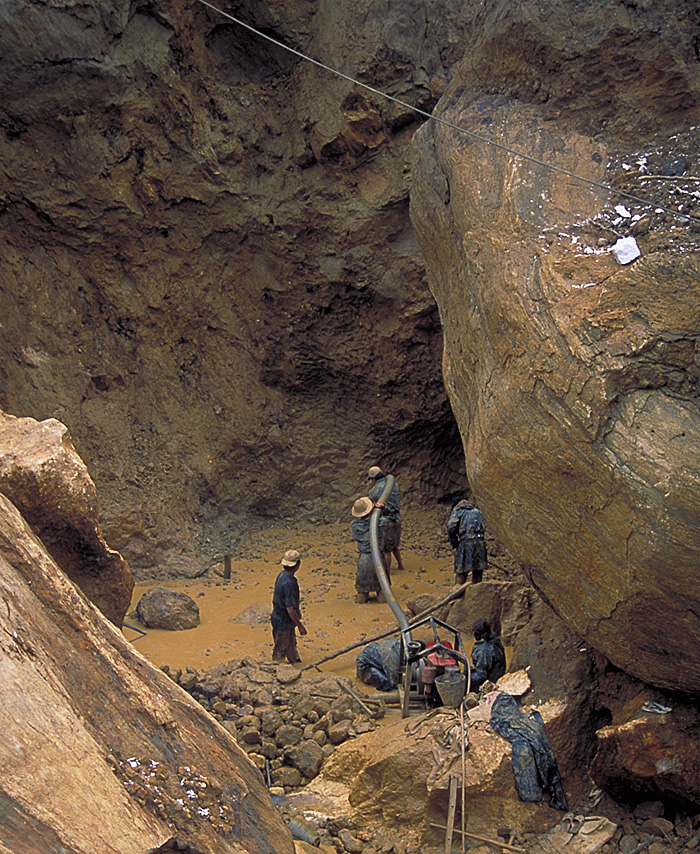 Miners at Inn Chauk, just north of Mogok, are dwarfed by massive limestone boulders as they hunt for rubies. Photo: R.W. Hughes