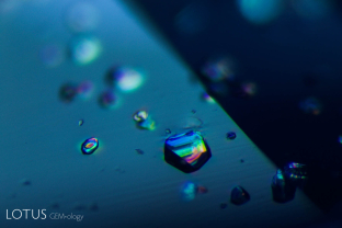 A transparent birefringent crystal reveals its doubly refractive nature when examined between crossed polars in this untreated sapphire from Sri Lanka.