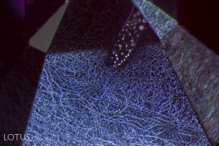 Bizarre spider's web clouds just beneath the surface of this ruby that proved to be beryllium treated.