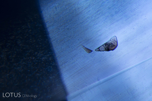 Small crystal plates against a backdrop of exsolved silk in this Sri Lankan sapphire.