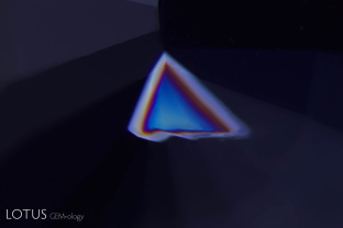 A triangular growth twin peeks out near the culet of this unheated violet sapphire from Sri Lanka.
