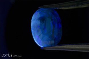 When low-iron sapphires are heat treated, a chalky shortwave fluorescence often develops. This generally is related to colorless or lightly colored regions of the gem, and so follows the crystallographic structure, as is seen here. This is strong evidence of heat treatment.