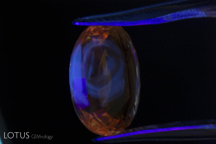 Low iron rubies (and pink and padparadscha sapphires) from localities like Mogok, Mong Hsu (Myanmar) and Sri Lanka will often display chalky zones in short wave ultraviolet after heat treatment. Here we see an excellent example in a heat-treated padparadscha sapphire from Sri Lanka. This fluorescence is positive proof of heat treatment.