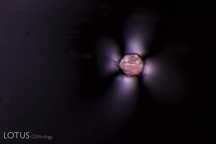 A birefringent crystal between crossed polars creates a striking image in this Vietnamese spinel.