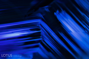 Angular growth zoning with fine texture clouds as seen with oblique fiber-optic illumination in a sapphire from Madagascar.