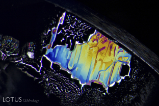 This iridescent inclusion in a Sri Lankan sapphire is a remnant of a fissure that has healed shut over millions of years. The trapped fluids in these types of inclusions can provide geologists and geochemists with valuable clues about the origins of the planet.