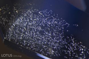 Planes of iron-rich silk float above fine clouds in this sapphire from a basaltic environment.