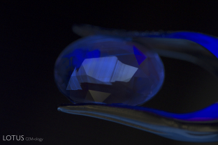 Zoned chalky green superficial fluorescence in Madagascar sapphire.