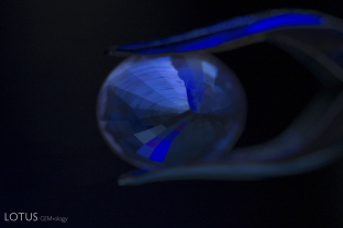 Zoned chalky green superficial fluorescence in Madagascar sapphire.