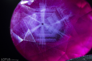 Hexagonally zoned clouds of diaspore silk create a trapiche-like pattern in unheated Mong Hsu (Burma) ruby.