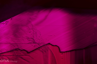Sharp growth zoning in this ruby evokes a fiery sunset blazing through a mountain range.