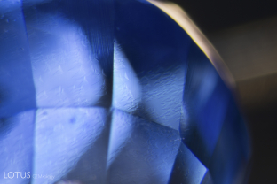 Triangular growth zoning in a Madagascar sapphire. Milky regions contrasting with deep blue zones are common in Madagascar sapphire.