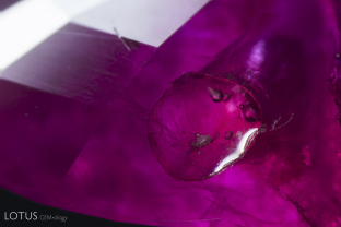 This ruby had a cavity that was filled with glass where small rounded gas bubbles can be seen.