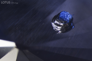An opaque crystal, likely iron sulphide, creates a striking image in this untreated Sri Lankan sapphire.