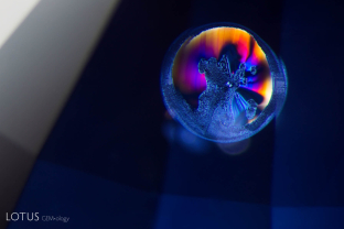 The melted, shiny fissure around this small crystal represents clear evidence that the sapphire host has been heat treated.