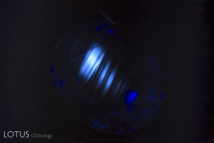 Angular zoned chalky shortwave fluorescent reaction, indicative of heat treatment.