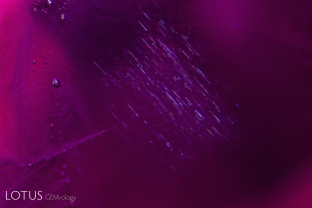 Mong Hsu rubies generally contain fluffy clouds of exsolved diaspore silk. While rutile silk is not common, it is seen on occasion, as evidenced by a cloud of rutile silk in a Mong Hsu ruby.