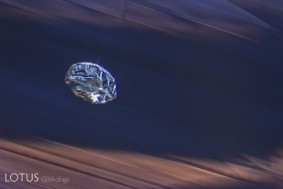 A euhedral apatite crystal floats within the milky depths of a sapphire from Madagascar. The apatite was identified by micro Raman. Note the fine texture and sharp growth zoning, both of which are hallmarks of many Madagascar sapphires.