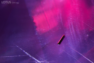 An elongated brown crystal stood out when we tested this ruby. Raman microscopy confirmed its identity as tourmaline.