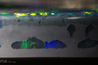 In this piece of opal, when viewed from the side, we can see where small pieces of precious opal are embedded inside the gray potch.