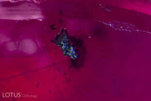 This ruby contained dozens of black crystal flakes strewn randomly across the stone; We used micro Raman to analyze one that broke the surface, revealing it to be graphite. Graphite has been found in many rubies across the Himalayan arc.