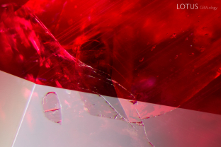A variety of crystals were present in this Madagascar ruby, which we tested with micro Raman. Analysis revealed that the rounded crystal on the left is apatite, the large block crystal in the center is amphibole, and the small rounded crystals are zircon.
