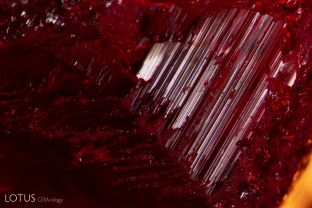 Step-like growth zoning on the surface of this Verneuil synthetic ruby is unusual.