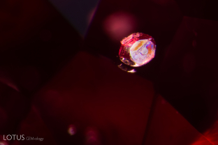 The euhedral crystal in this spinel displays a beautiful iridescent surface.