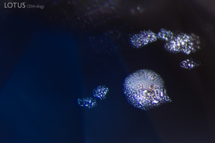 Mirroring the play of light on water, thin-film inclusions shimmer within this sapphire.