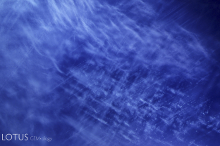 Kashmir cloud scene in natural Kashmir sapphire. These fine clouds, which are so small that they have never been definitively identified, are responsible for the famous velvet texture of these Himalayan blues. 15x.