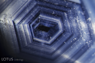 A clear hexagonal growth pattern forms shimmering angular zones in this sapphire from New South Wales, Australia. Specimen courtesy of Terrence Coldham.