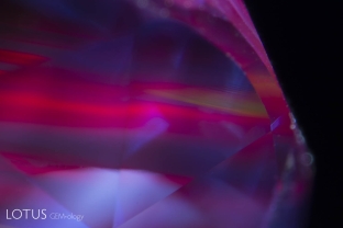 Red fluorescence from red color zones, along with one unusual zone of yellow fluorescence in a blue sapphire from Sri Lanka.