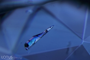 A large birefringent missile takes flight within this sapphire from Sri Lanka.